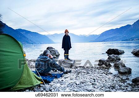 Father and son camping by lakeside, Onno, Lombardy, Italy View Large Photo Image Stock Image - Father and son camping by lakeside, Onno, Lombardy, Italy. Fotosearch