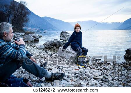 Father and son on lakeside, Onno, Lombardy, Italy View Large Photo Image Stock Image - Father and son on lakeside, Onno, Lombardy, Italy. Fotosearch