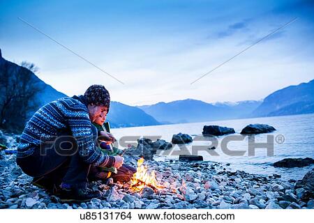Father and son toasting marshmallows over campfire, Onno, Lombardy, Italy View Large Photo Image Picture - Father and son toasting marshmallows over campfire, Onno, Lombardy, Italy. Fotosearch
