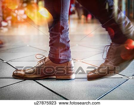 Feet in pair of brogues on tiled flooring View Large Photo Image Stock Image - Feet in pair of brogues on tiled flooring. Fotosearch