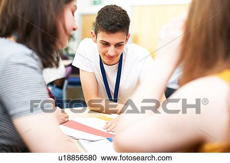 Female and male higher education students studying in college classroom, over shoulder view View Large Photo Image Stock Image - Female and male higher education students studying in college classroom, over shoulder view. Fotosearch