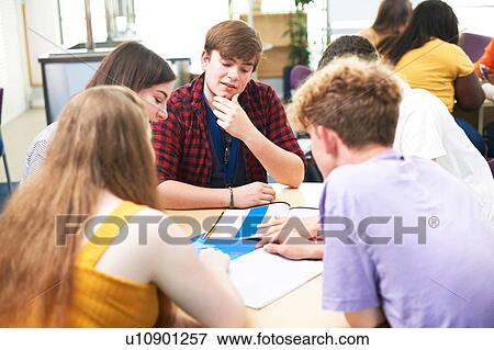 Female and male higher education students discussing project in college classroom View Large Photo Image Stock Photo - Female and male higher education students discussing project in college classroom. Fotosearch