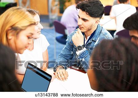 Female and male higher education students studying in college classroom, over shoulder view View Large Photo Image Stock Photo - Female and male higher education students studying in college classroom, over shoulder view. Fotosearch