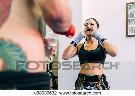Female boxer putting on mouth guard View Large Photo Image Stock Image - Female boxer putting on mouth guard. Fotosearch