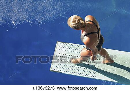 Stock Image - Female diver on springboard. Fotosearch