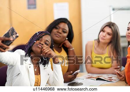 Female higher education students taking selfie in college classroom View Large Photo Image Stock Photo - Female higher education students taking selfie in college classroom. Fotosearch