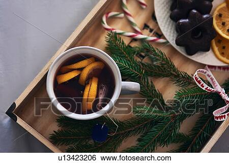 Stock Photograph - Festive tray of warm drink, Christmas biscuits and Yew tree branch. Fotosearch