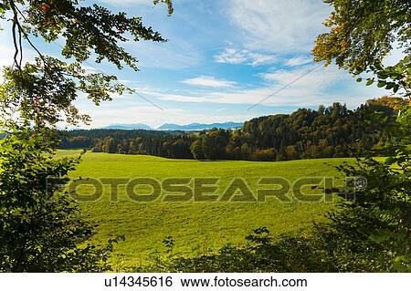 Field landscape with distant forests and mountains, Bavaria, Germany View Large Photo Image Stock Photograph - Field landscape with distant forests and mountains, Bavaria, Germany. Fotosearch