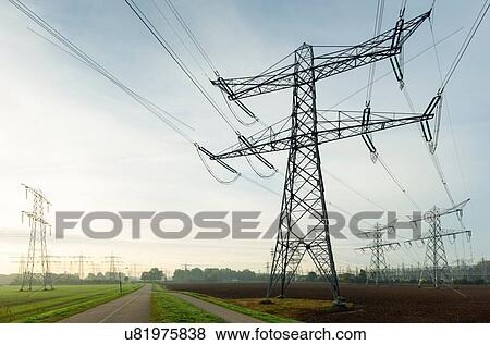 Stock Photo - Field landscape with power lines near coal fired power station, Netherlands. Fotosearch