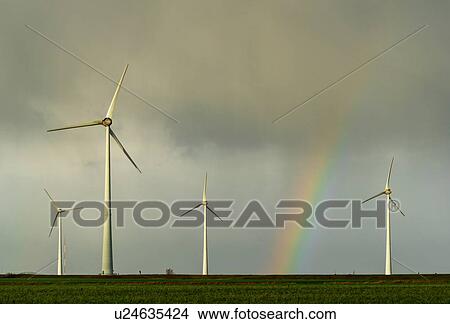 Field landscape with rainbow between turbines on wind farm in north Netherlands, near waddensea dyke View Large Photo Image Picture - Field landscape with rainbow between turbines on wind farm in north Netherlands, near waddensea dyke. Fotosearch