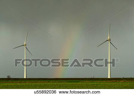Field landscape with rainbow between two turbines on wind farm in north Netherlands, near waddensea dyke View Large Photo Image Stock Photograph - Field landscape with rainbow between two turbines on wind farm in north Netherlands, near waddensea dyke. Fotosearch