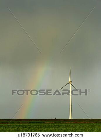 Stock Photography - Field landscape with rainbow by turbine on wind farm in north Netherlands, near waddensea dyke. Fotosearch