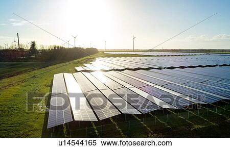 Stock Photography - Field landscape with the largest solar farm in Netherlands, situated near Delfzijl harbour. Fotosearch