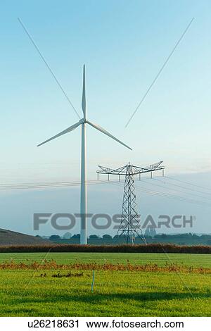 Stock Image - Field landscape with wind turbine and pylon in autumn, Netherlands. Fotosearch