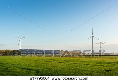 Picture - Field landscape with wind turbines and solar farm located on a former waste dump in autumn, Netherlands. Fotosearch