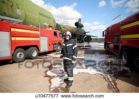 Fire training, fireman by fire engines at training facility, portrait View Large Photo Image Stock Photo - Fire training, fireman by fire engines at training facility, portrait. Fotosearch
