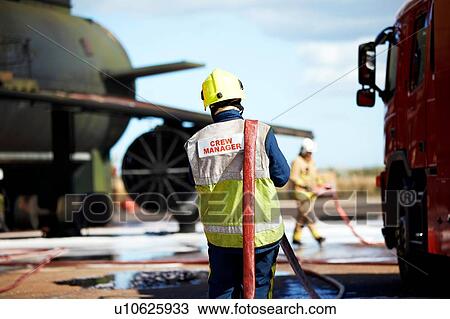Fireman carrying fire hose over shoulder, Darlington, UK View Large Photo Image Stock Image - Fireman carrying fire hose over shoulder, Darlington, UK. Fotosearch