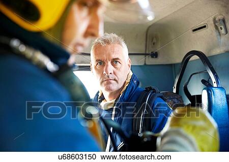 Stock Image - Fireman inside fire engine. Fotosearch