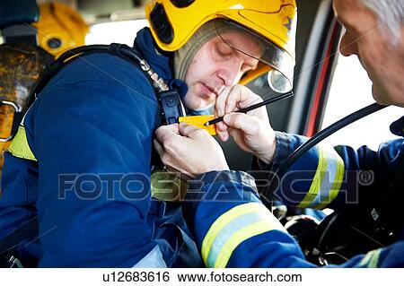 Stock Photograph - Fireman inside fire engine. Fotosearch