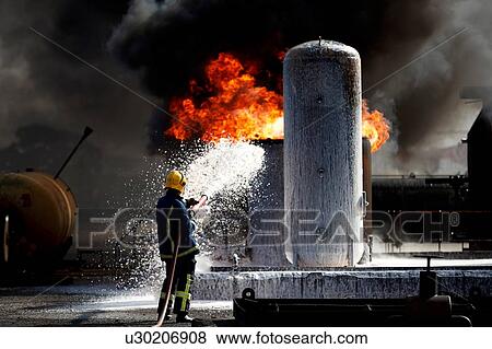 Fireman training to put out fire on burning tanks, Darlington, UK View Large Photo Image Stock Photo - Fireman training to put out fire on burning tanks, Darlington, UK. Fotosearch