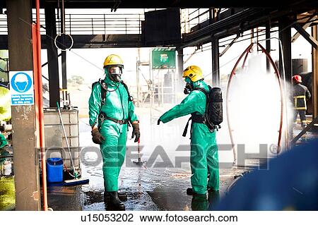 Stock Image - Firemen in discussion in training centre, Darlington, UK. Fotosearch