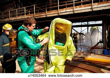 Firemen putting on fire proximity suit in training centre, Darlington, UK View Large Photo Image Picture - Firemen putting on fire proximity suit in training centre, Darlington, UK. Fotosearch