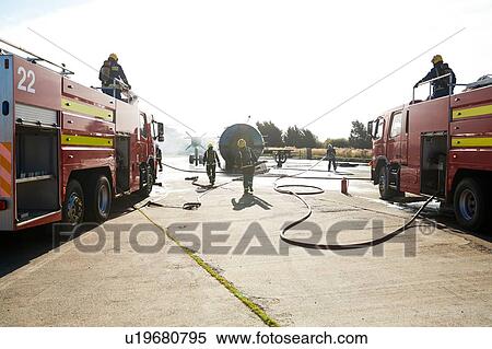 Firemen putting out fire on old training aeroplane, Darlington, UK View Large Photo Image Stock Photography - Firemen putting out fire on old training aeroplane, Darlington, UK. Fotosearch