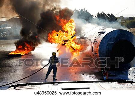 Stock Photography - Firemen putting out fire on old training aeroplane, Darlington, UK. Fotosearch
