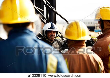 Firemen training, firemen listening to supervisor, over the shoulder view View Large Photo Image Stock Image - Firemen training, firemen listening to supervisor, over the shoulder view. Fotosearch