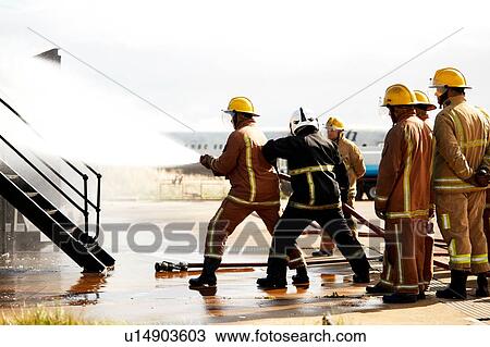Firemen training, firemen spraying water at training facility View Large Photo Image Stock Image - Firemen training, firemen spraying water at training facility. Fotosearch