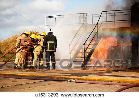 Firemen training, firemen spraying water at training facility stairway View Large Photo Image Stock Image - Firemen training, firemen spraying water at training facility stairway. Fotosearch