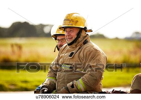 Picture - Firemen training, firemen taking a break at training facility. Fotosearch