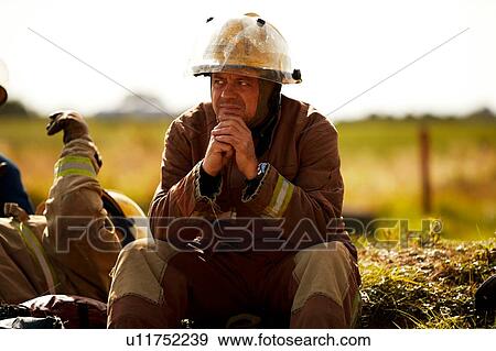 Stock Photo - Firemen training, firemen taking a break at training facility. Fotosearch