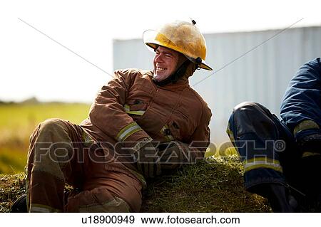 Stock Photo - Firemen training, firemen taking a break at training facility. Fotosearch
