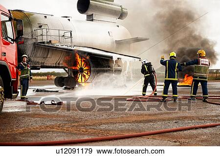 Firemen training, spraying water at mock airplane engine View Large Photo Image Stock Photo - Firemen training, spraying water at mock airplane engine. Fotosearch