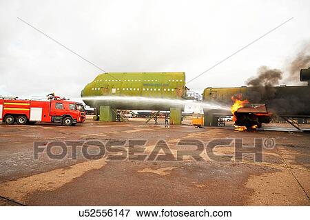 Firemen training, spraying water from fire engine at mock airplane View Large Photo Image Stock Photo - Firemen training, spraying water from fire engine at mock airplane. Fotosearch