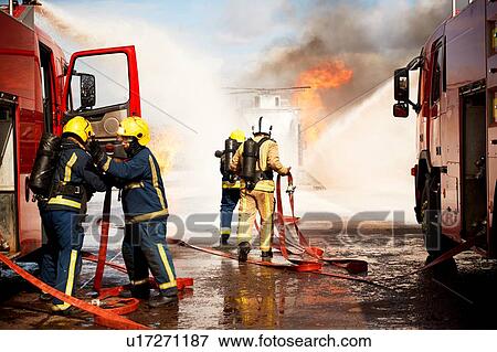 Firemen training, team of firemen extinguishing mock helicopter fire at training facility View Large Photo Image Stock Photo - Firemen training, team of firemen extinguishing mock helicopter fire at training facility. Fotosearch
