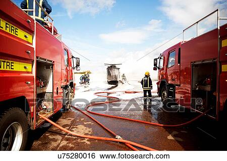 Firemen training, team of firemen spraying firefighting foam at mock helicopter at training facility View Large Photo Image Stock Photograph - Firemen training, team of firemen spraying firefighting foam at mock helicopter at training facility. Fotosearch