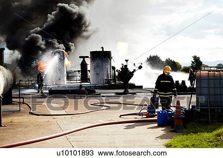 Firemen training to put out fire on burning tanks, Darlington, UK View Large Photo Image Stock Image - Firemen training to put out fire on burning tanks, Darlington, UK. Fotosearch