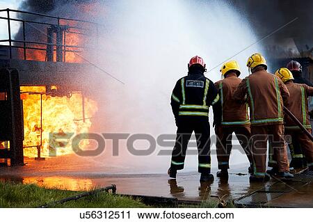 Firemen training to put out fire on burning building, Darlington, UK View Large Photo Image Stock Image - Firemen training to put out fire on burning building, Darlington, UK. Fotosearch