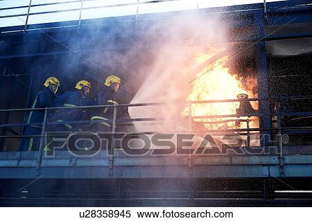 Firemen training to put out fire on burning building, Darlington, UK View Large Photo Image Stock Photography - Firemen training to put out fire on burning building, Darlington, UK. Fotosearch