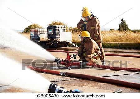 Firemen training to use fire hose, Darlington, UK View Large Photo Image Stock Image - Firemen training to use fire hose, Darlington, UK. Fotosearch