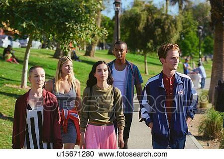 Stock Image - Five young adult friends strolling in park, Los Angeles, California, USA. Fotosearch