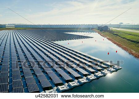 Floating solar panels installed on water supply of neighbouring greenhouses, elevated view, Netherlands View Large Photo Image Stock Image - Floating solar panels installed on water supply of neighbouring greenhouses, elevated view, Netherlands. Fotosearch