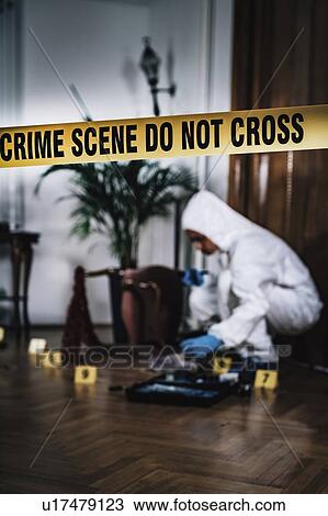 Stock Image - Forensics expert collecting evidence. Fotosearch