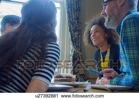 Stock Image - Friends celebrating birthday in pub. Fotosearch