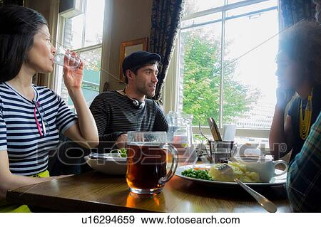 Friends having pub lunch View Large Photo Image Stock Photo - Friends having pub lunch. Fotosearch