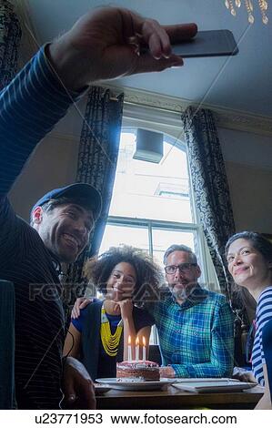 Friends taking selfie of birthday celebration in pub View Large Photo Image Stock Image - Friends taking selfie of birthday celebration in pub. Fotosearch