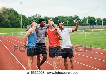Friends taking selfie on running track View Large Photo Image Stock Image - Friends taking selfie on running track. Fotosearch