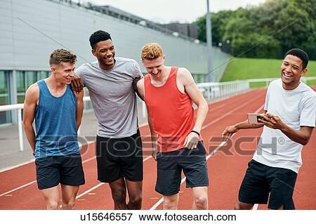 Friends talking on running track View Large Photo Image Stock Photo - Friends talking on running track. Fotosearch